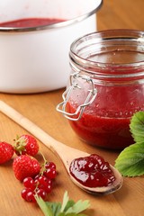 Strawberry jam and berry fruits.
