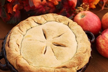 Arrangement of home-made apple pie and apples.
