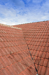 Tiled Roof with Fluffy Cloud Blue Sky