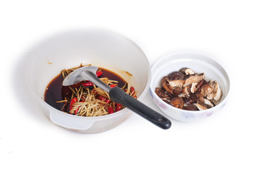 Cooking of steamed grouper with mashroom isolated on white