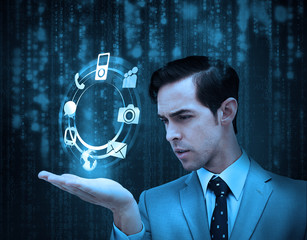 Businessman holding a hologram with smartphone applications