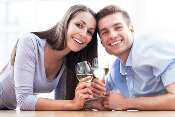 Couple on floor drinking wine