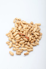 .Dried peanuts in closeup on the white background