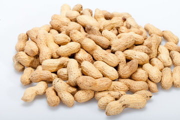 .Dried peanuts in closeup on the white background