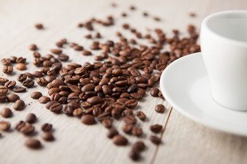 coffee cup with coffee beans scattered