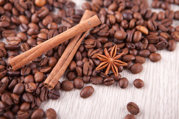 two cinnamon sticks and  coffee beans