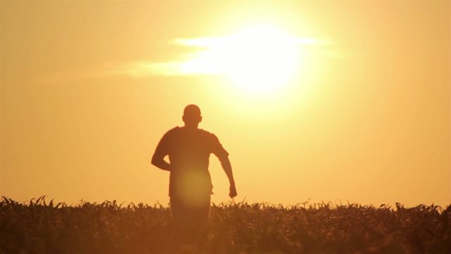 silhouette of a man walking at sunrise