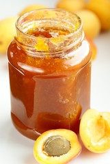 Glass with apricot jam and fresh apricots
