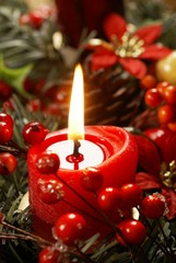 Close up of candle and Christmas decorations.