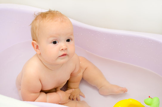 Surprised baby in the bath