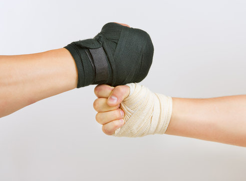 Two hands clasped arm wrestling, the struggle of black and white