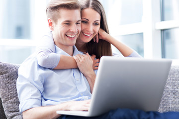 Couple on sofa with laptop