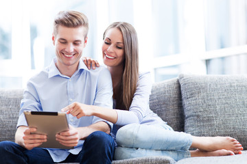 Couple on sofa with digital tablet