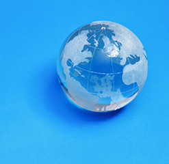 glass globe , isolated on blue background