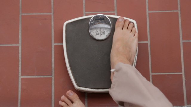 Man on retro bathroom scales