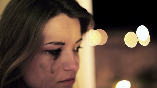 Beautiful sad woman crying in the night
