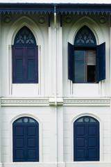 Fototapeta na wymiar One opened blue window on a Thai vintage building architecture