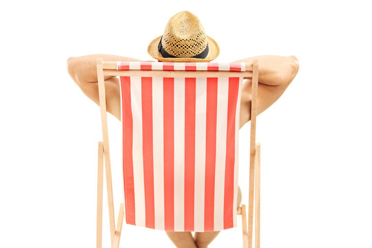 Man with hat sitting on a beach chair
