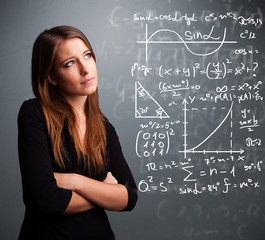 Beautiful school girl thinking about complex mathematical signs