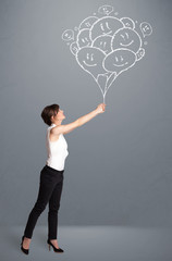 Happy woman holding smiling balloons drawing