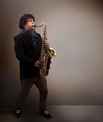 Fototapeta na wymiar Young musician playing on saxophone