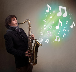 Young musician playing on saxophone while musical notes explodin