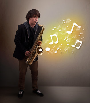 Handsome musician playing on saxophone with musical notes