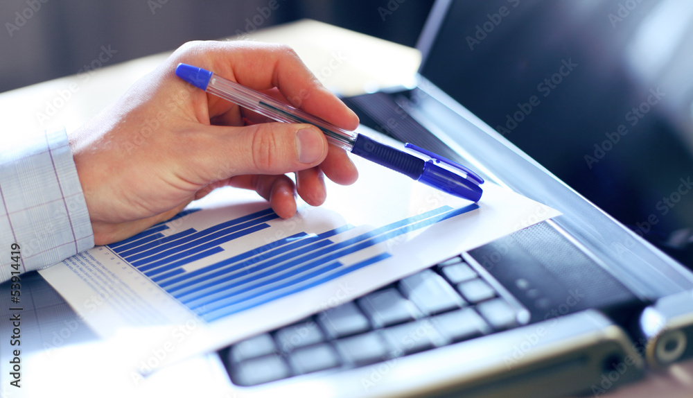 Aufkleber Image of hand pointing on a graph data. Selective focus