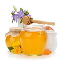 glass jar full of honey and stick