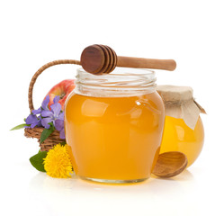 glass jar full of honey and stick