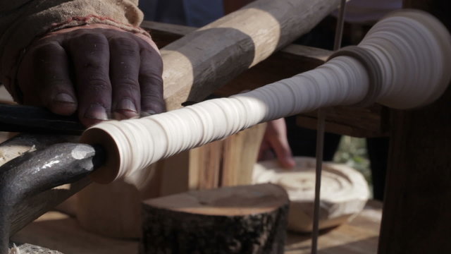 Craftsman turning wood on a vintage lathe