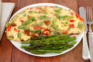 omelette with vegetables and asparagus on the plate