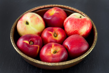 nectarine in dish on dark background