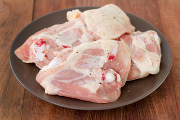 raw chicken on brown plate