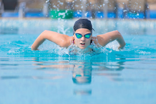 Young Girl Swimming Butterfly Stroke Style