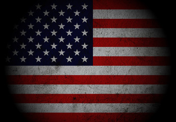 Dark grunge textured US Flag with spot light.