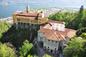 Naklejka premium Madonna del Sasso, medieval monastery on the rock overlook lake