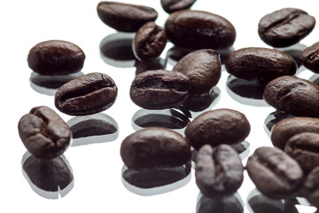 Coffee beans on a mirroring surface