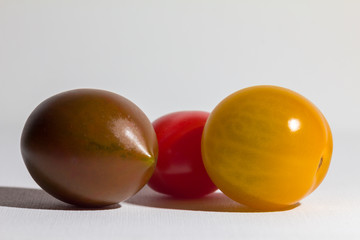 Three different kinds of cherry tomatoes (brown, red, yellow)
