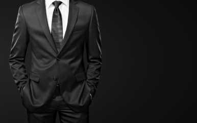 man in suit on black background