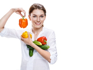 promo girl holding a paprika and cucumbers - isolated on white