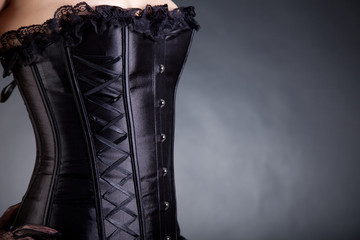 Close-up shot of a woman in black corset - obrazy, fototapety, plakaty