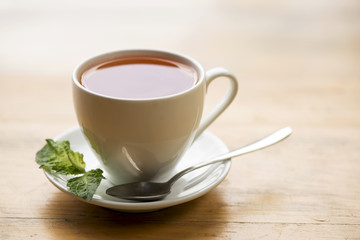 cup of aromatic tea on wooden table