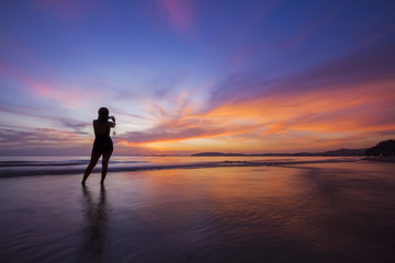 Fototapeta na wymiar Silhouette girl in amazing sunset.