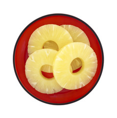 Pineapple rings on red dish