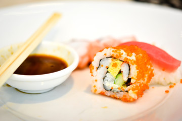 Sushi on the white dish with sauce