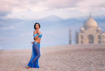 Belly dancer with an image of eastern palace in the distance