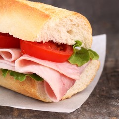 Close-up of baguette with ham, lettuce and tomatoes