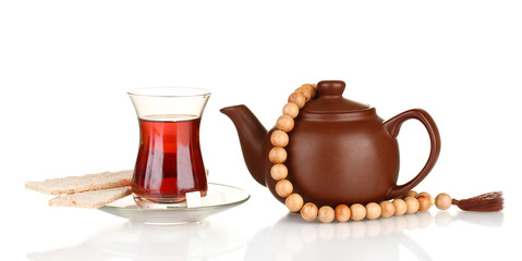 glass of Turkish tea and kettle isolated on white