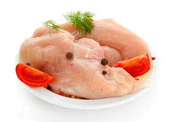 raw chicken meat with spices on plate, isolated on white